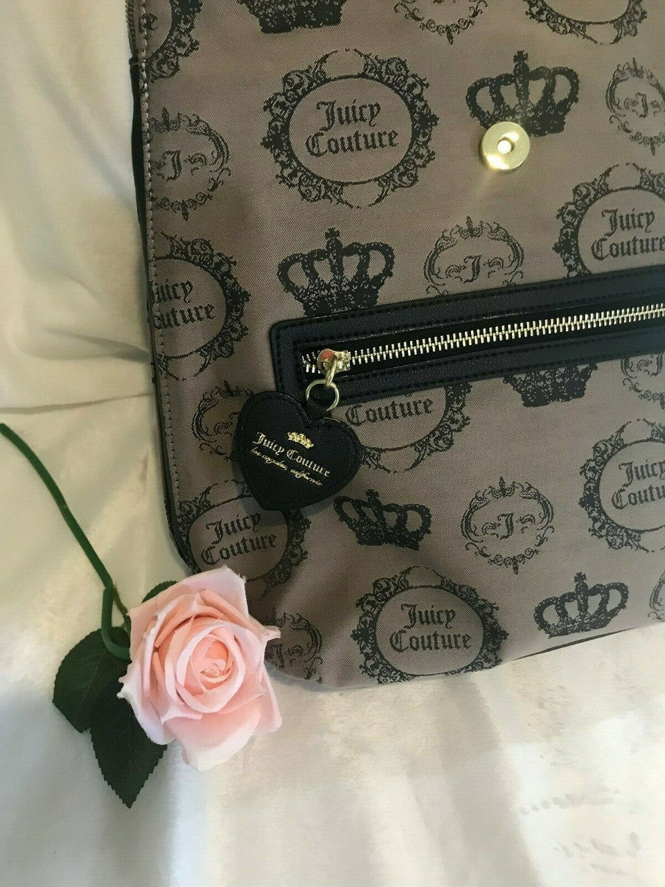 Beige and black canvas backpack with gold Juicy Couture logo and medallion design