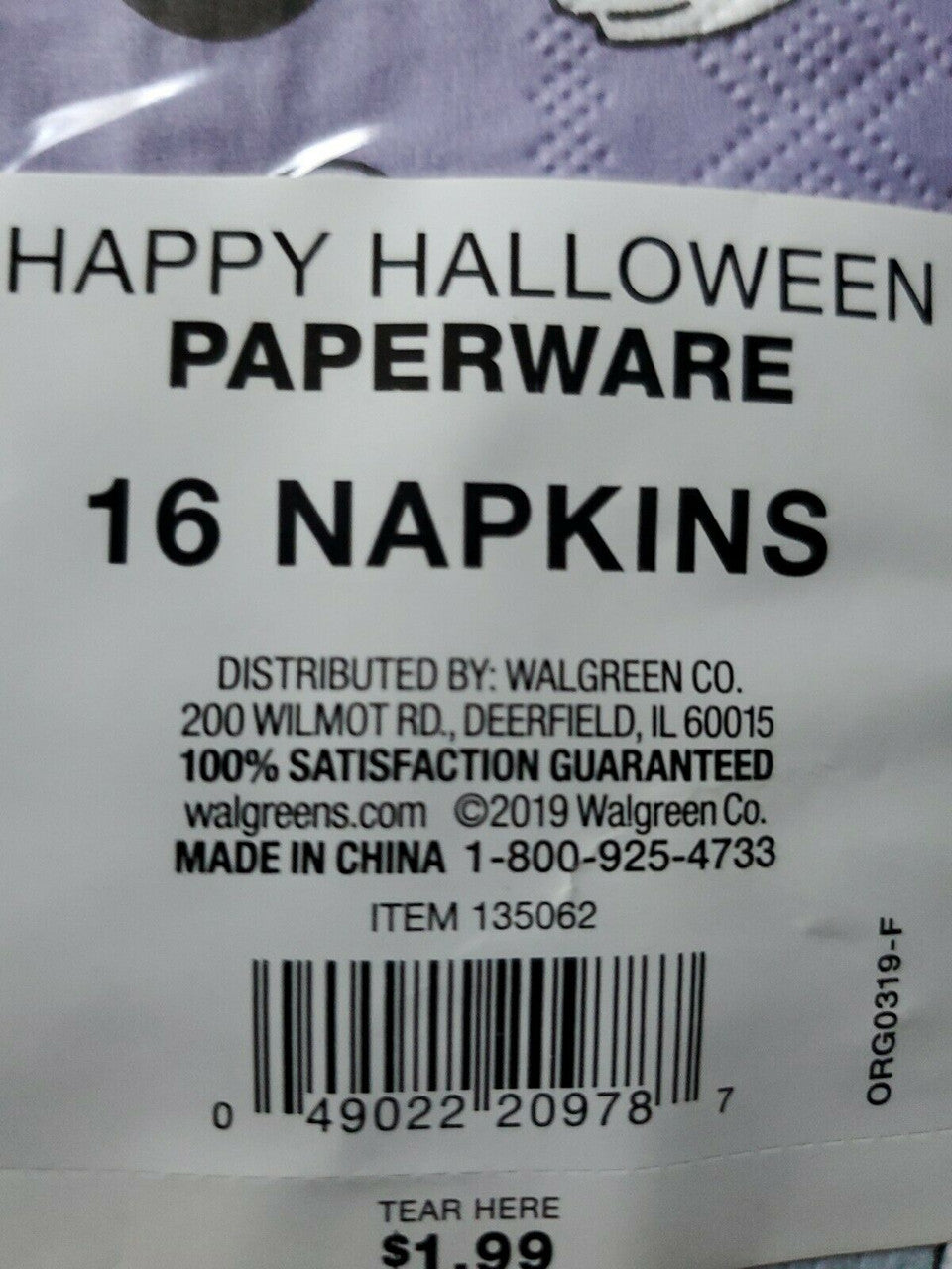 Stack of purple Halloween paper napkins with white ghost and BOO design in packaging