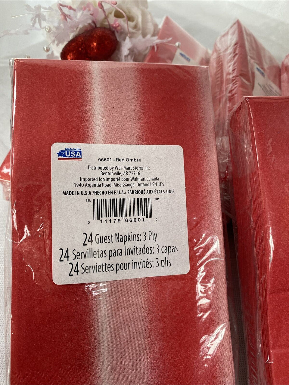Six packs of red ombre paper guest napkins wrapped in packaging, 3-ply disposable napkins by Diva made in the USA