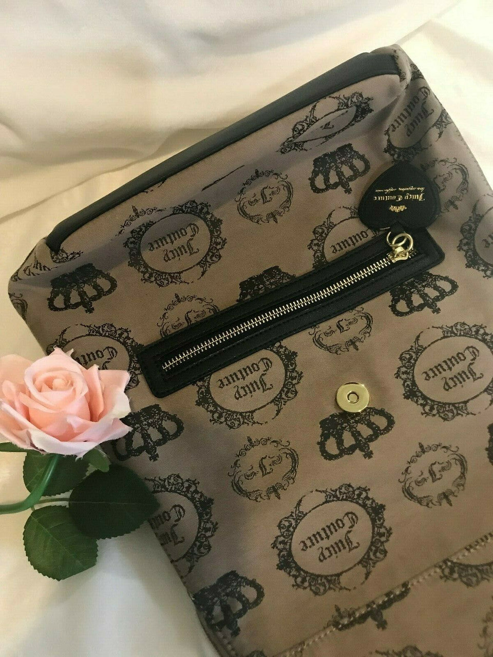 Beige and black canvas backpack with gold Juicy Couture logo and medallion design