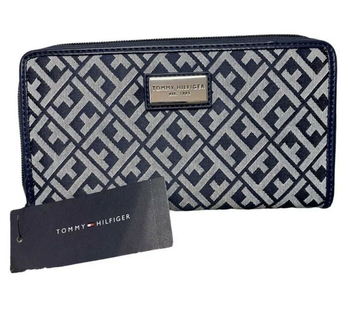 Tommy Hilfiger navy blue wallet with monogram print and silver logo plaque, shown with interior compartments.