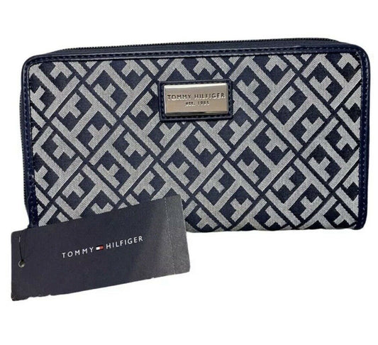 Tommy Hilfiger navy blue wallet with monogram print and silver logo plaque, shown with interior compartments.
