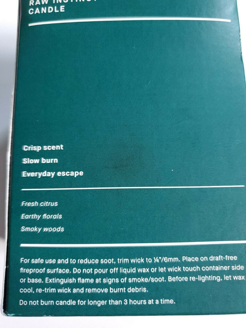 Crabtree & Evelyn Raw Instinct scented candle in green glass jar with copper lid, 8.8 oz premium soy wax blend.