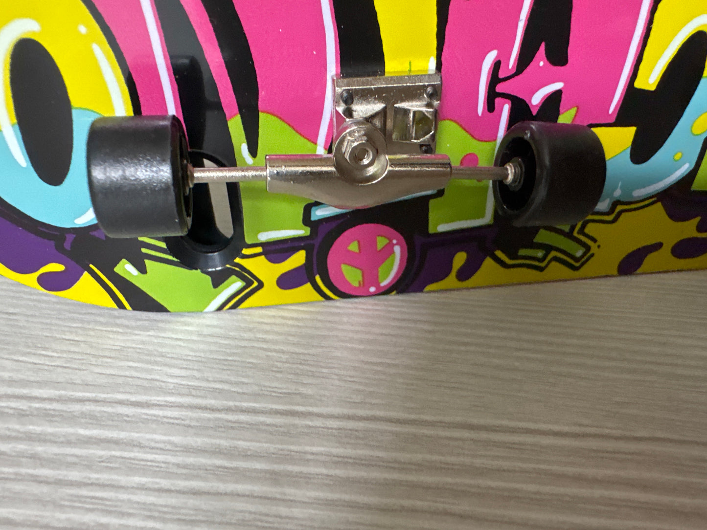 Colorful MOSCHINO printed iPhone 6 case displayed vertically, shaped like a skateboard, boxed