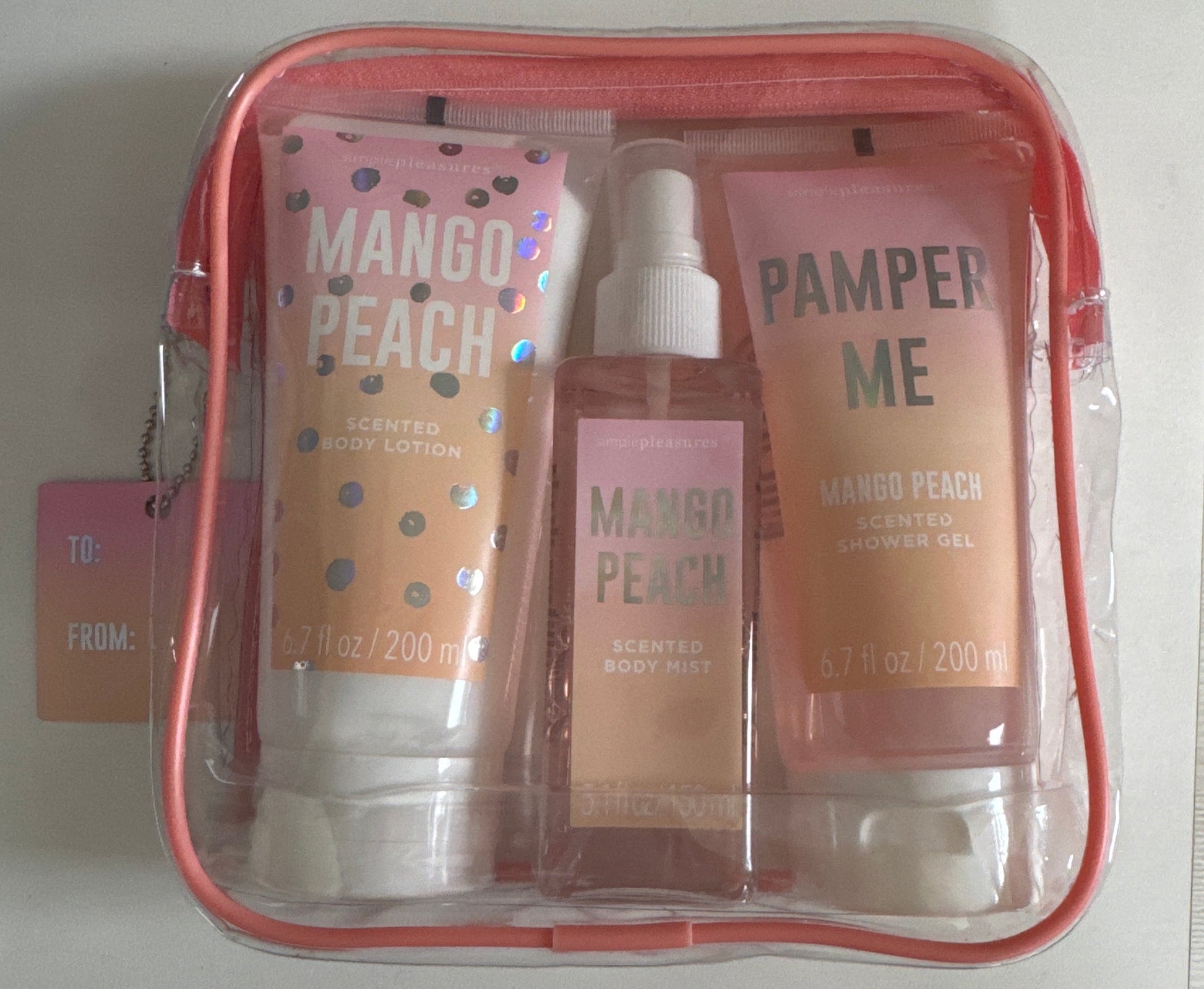 Simple Pleasures full-size mango peach body care set with lotion, mist, and shower gel in pink zip pouch