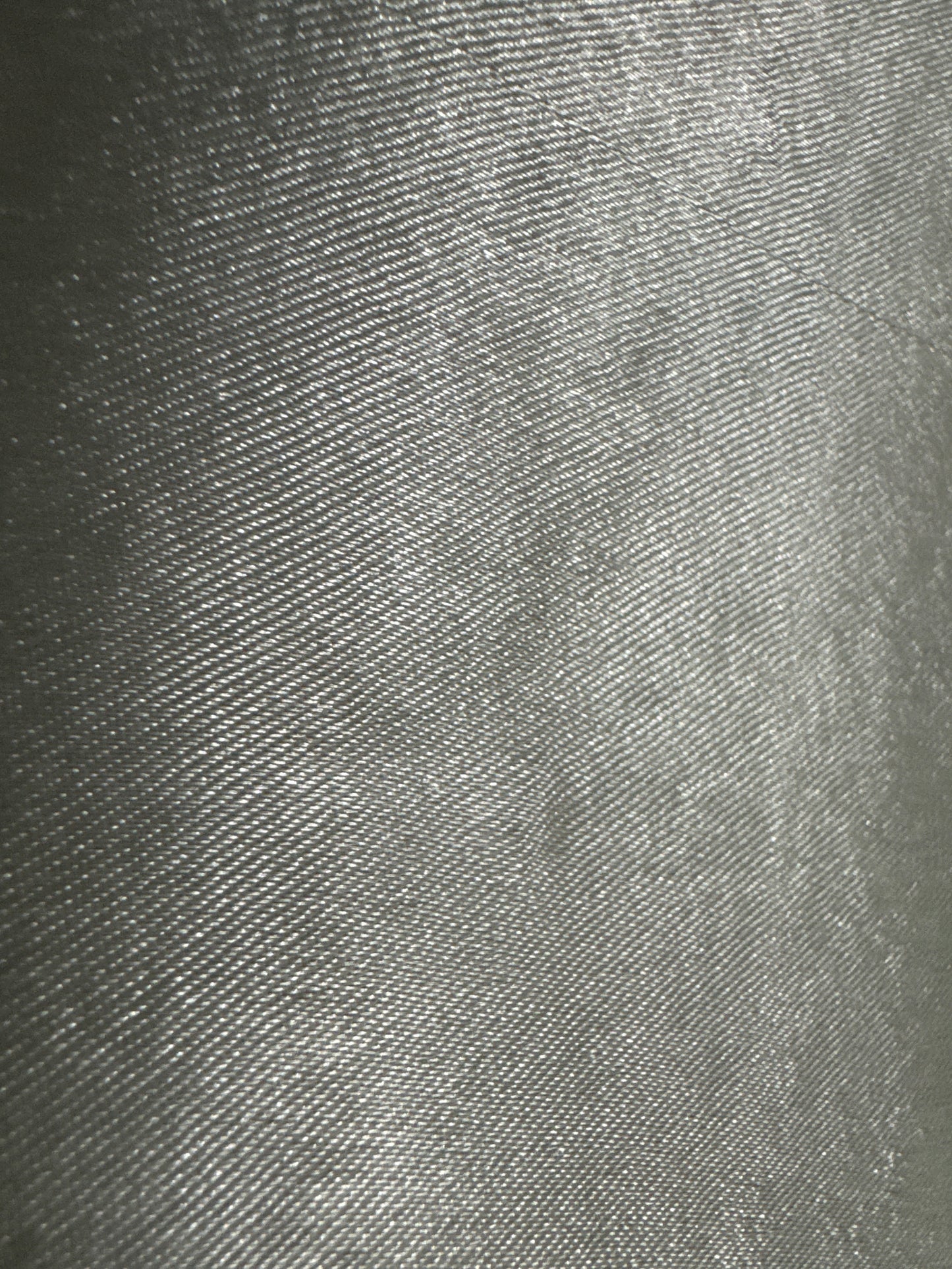 Back view of a beaded placemat with a smooth, silver-toned surface, showcasing a sleek and metallic finish.