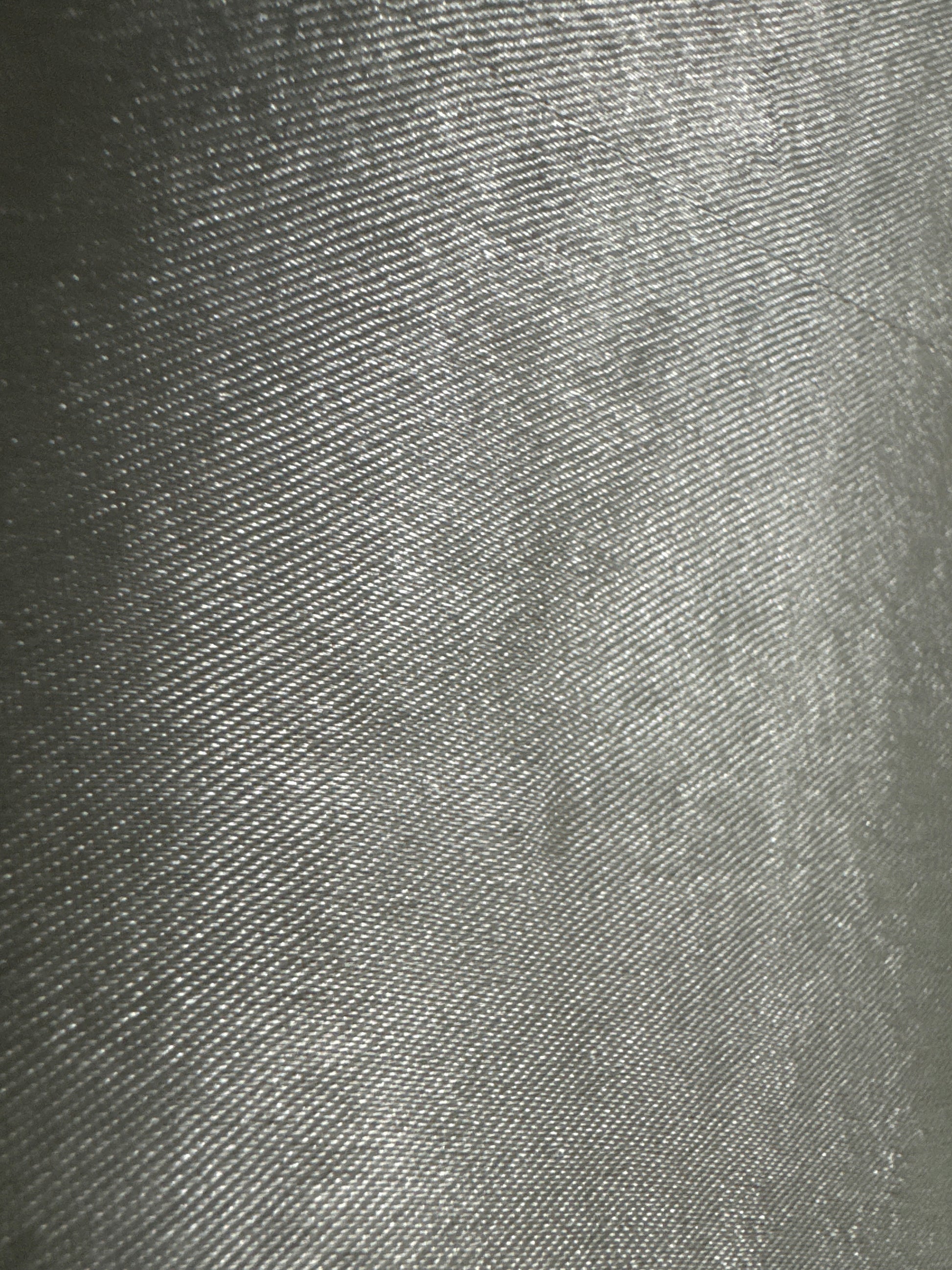 Back view of a beaded placemat with a smooth, silver-toned surface, showcasing a sleek and metallic finish.