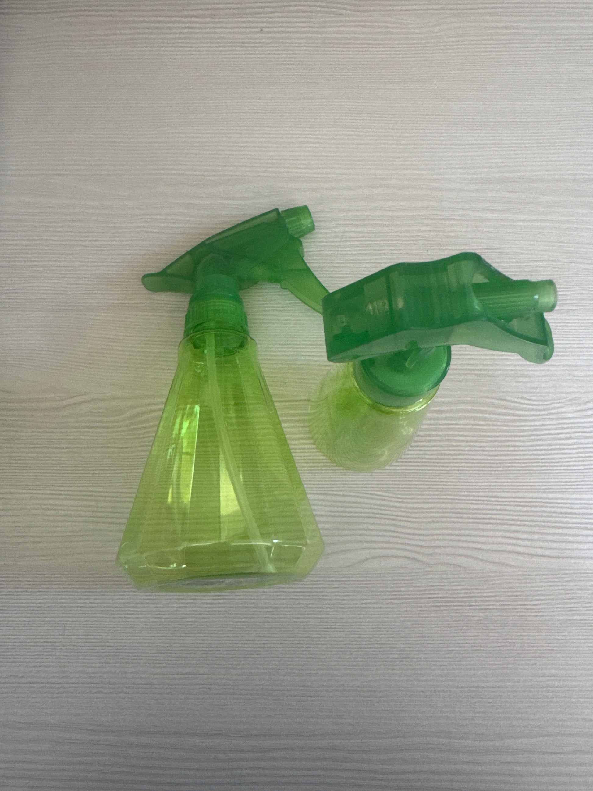 Green plastic spray bottle with trigger sprayer