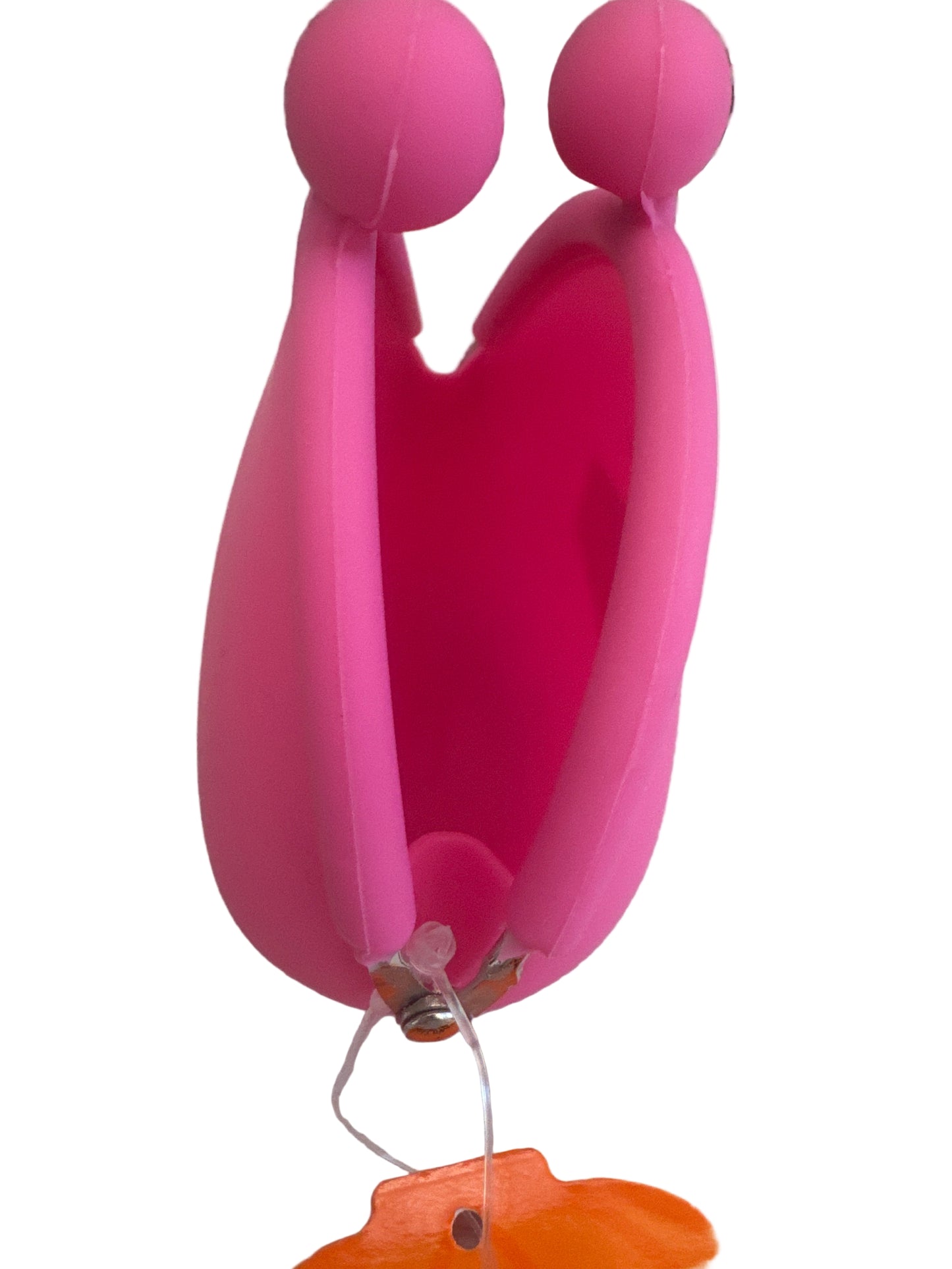 Bright pink silicone coin purse with clasp closure, photographed on a light surface