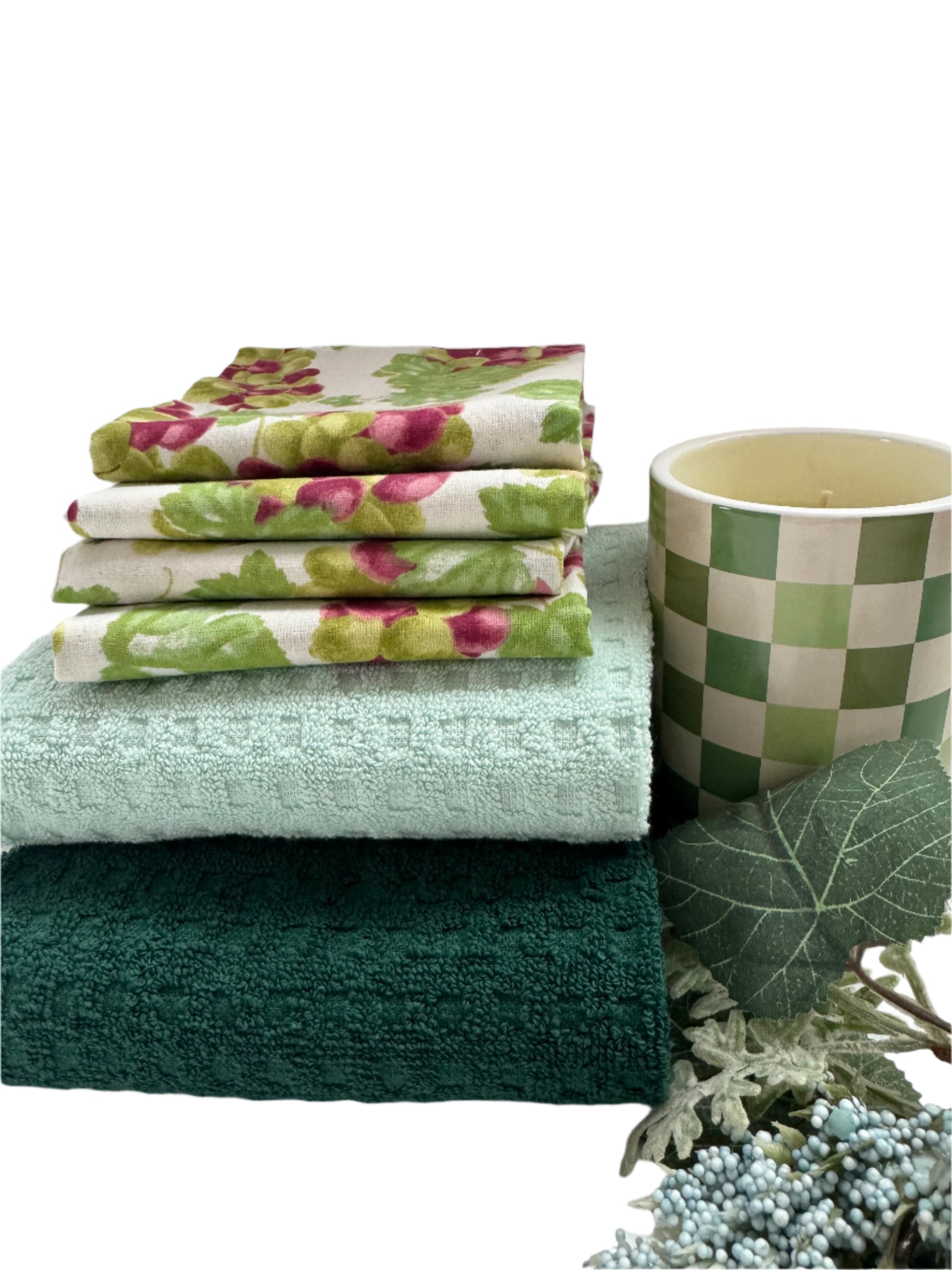 Charming kitchen gift set featuring 4 hand-screen printed cotton napkins with a grape design, 2 cotton towels in soft pastel green and teal, and a yellow scented candle. Perfect for enhancing your kitchen or as a thoughtful gift. The set showcases elegant, functional kitchen essentials