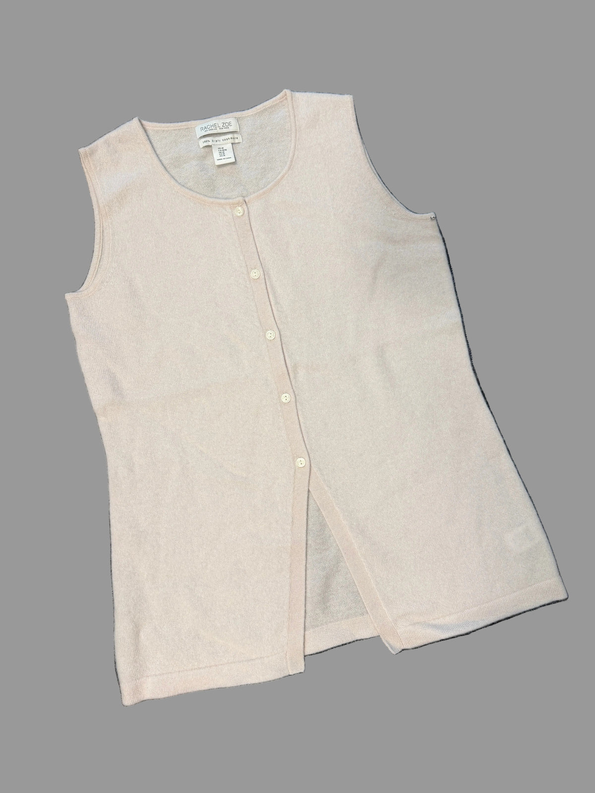 A light beige sleeveless knit vest with a button-up front,