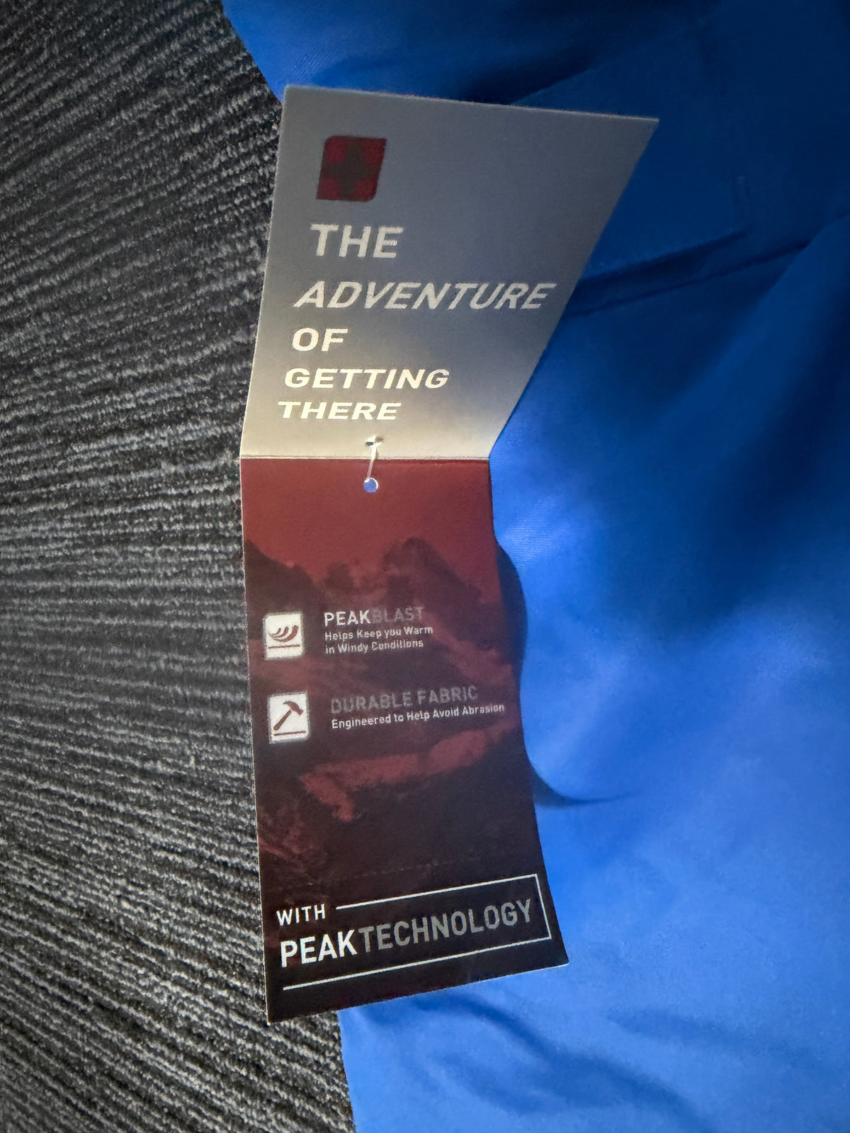 A Peak Technology card , with the text 'THE ADVENTURE OF GETTING THERE' and 'WITH PEAK TECHNOLOGY' visible.
