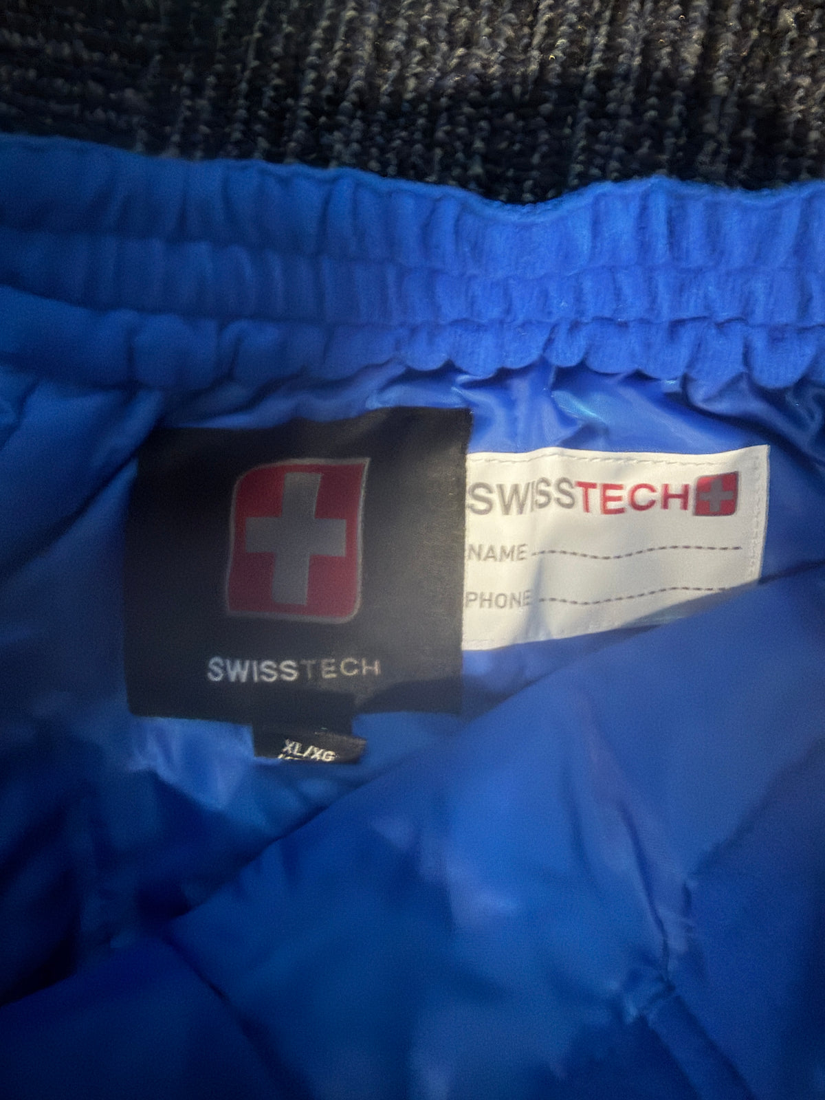 snow pants SwissTech brand label with a red Swiss cross logo.