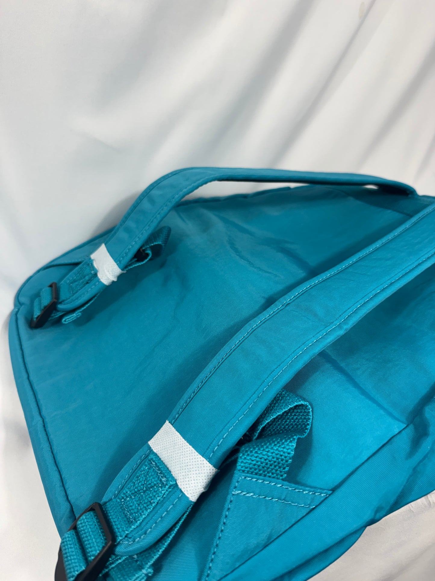 Blue bag with white accents on a light gray background