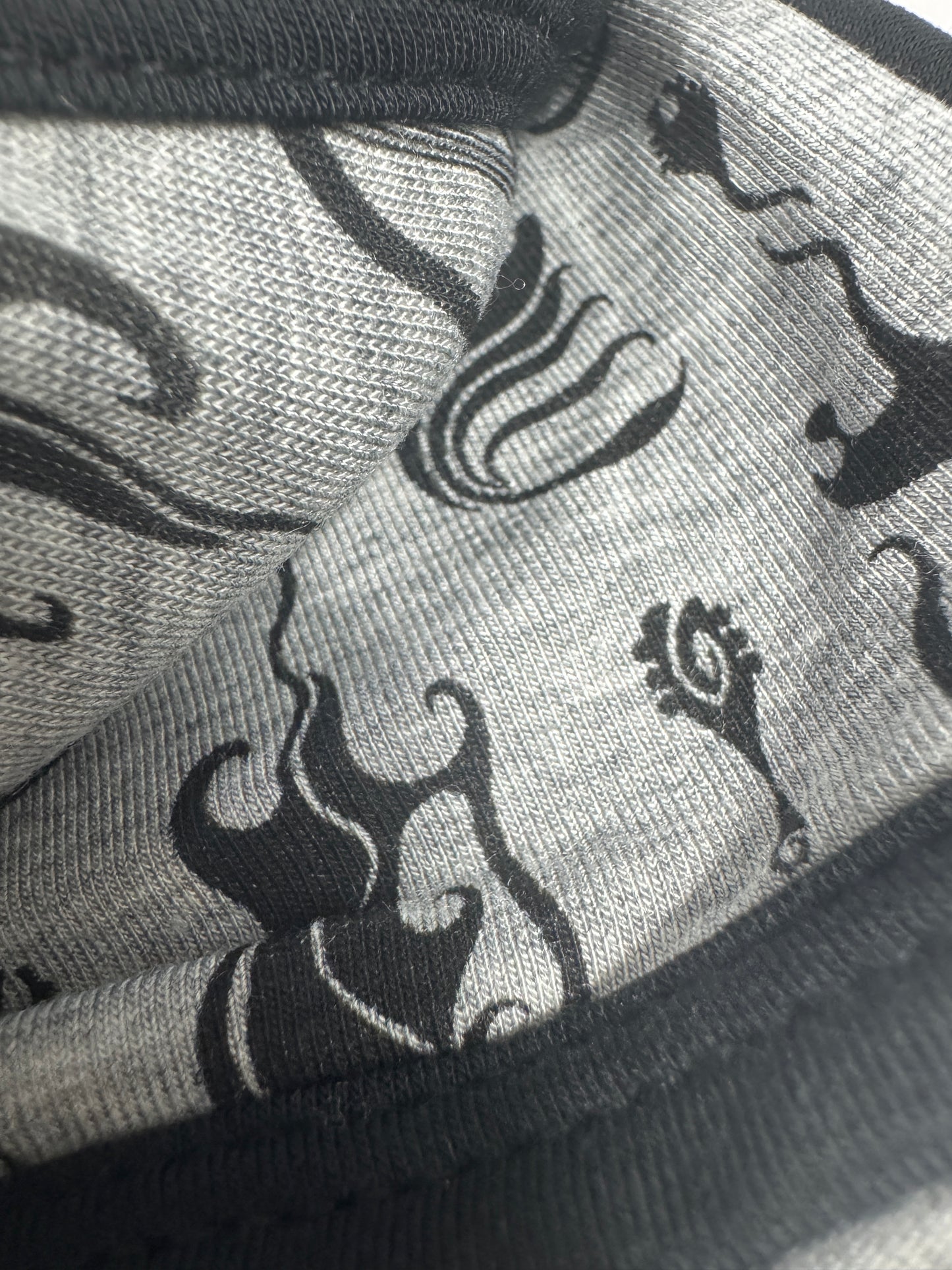 Close-up of fabric with black patterns on a gray background