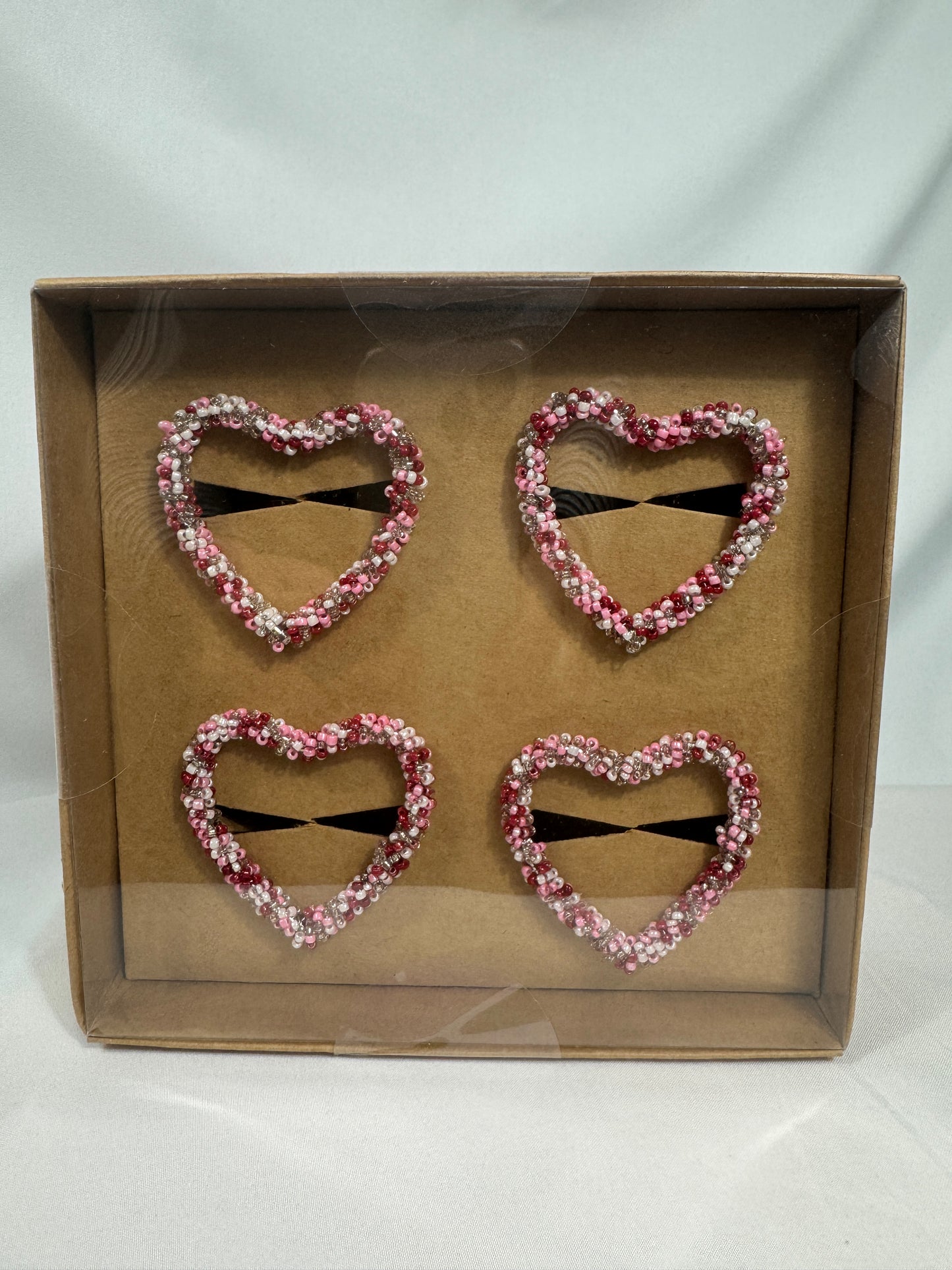 Set of four pink and red and white napking rings heart shape