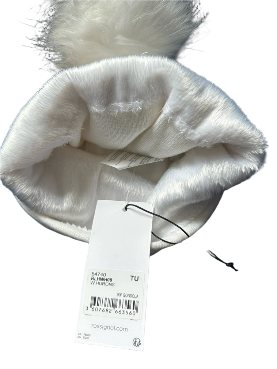 White beanie with multicolor gondola print and white faux-fur pom.