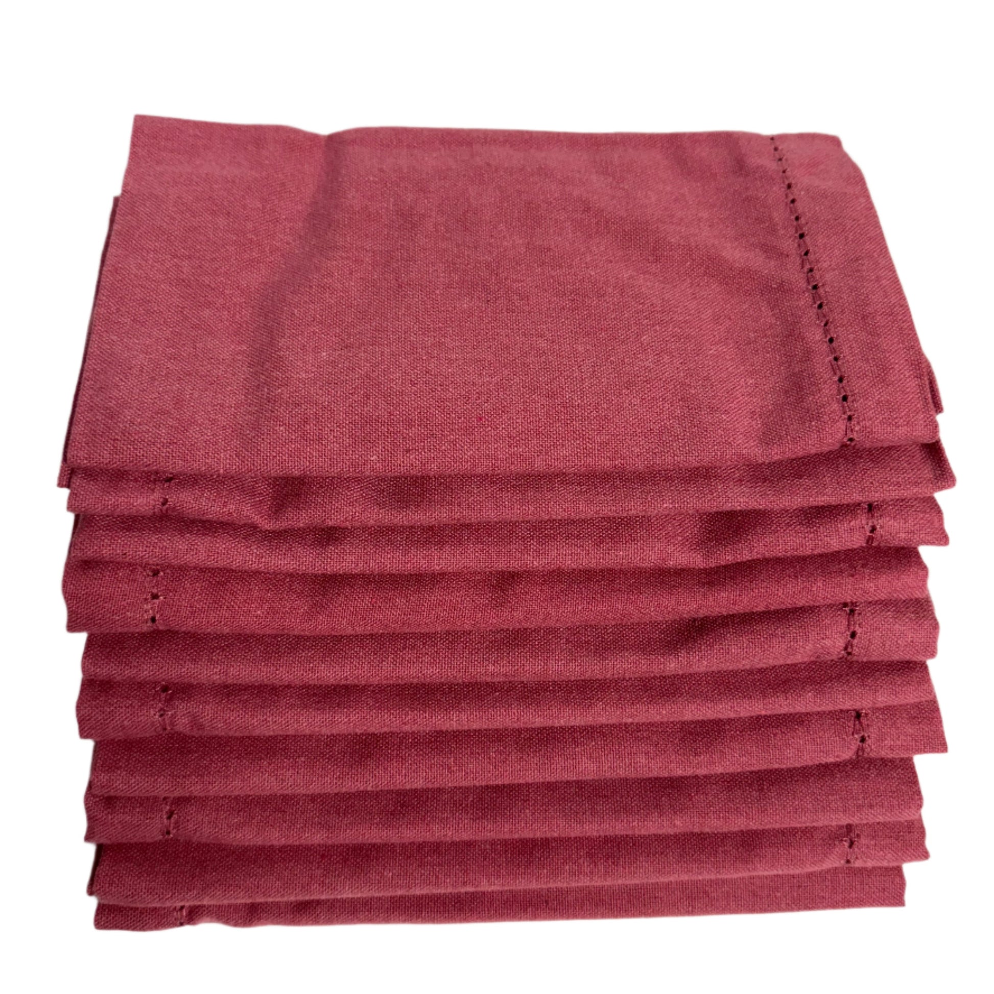 Stack of folded burgundy cotton napkins, neatly arranged with a fine stitched edge, showcasing a polished and clean appearance