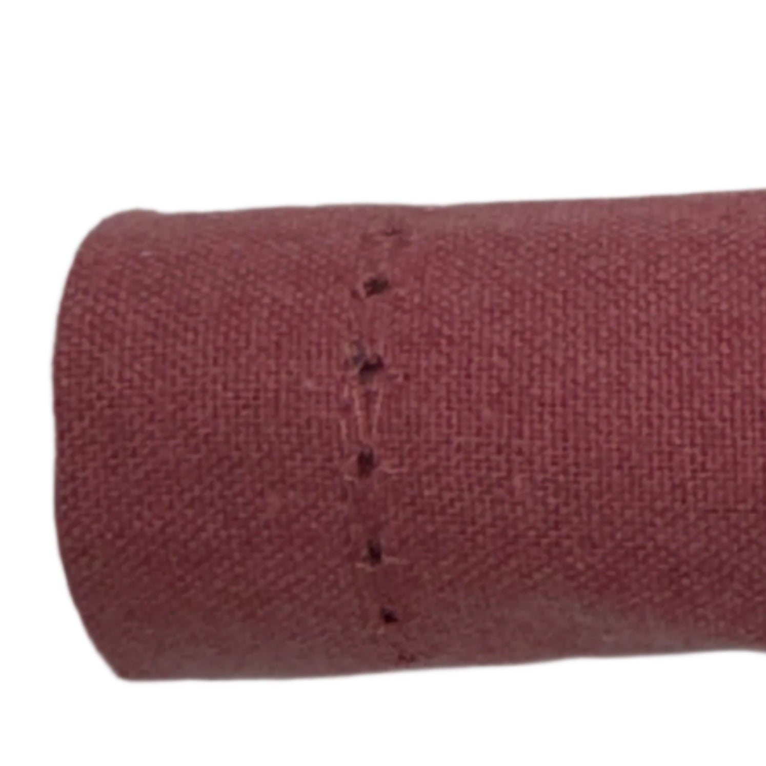Close-up of a rolled cotton napkin in burgundy, showcasing the fine stitching along the edge