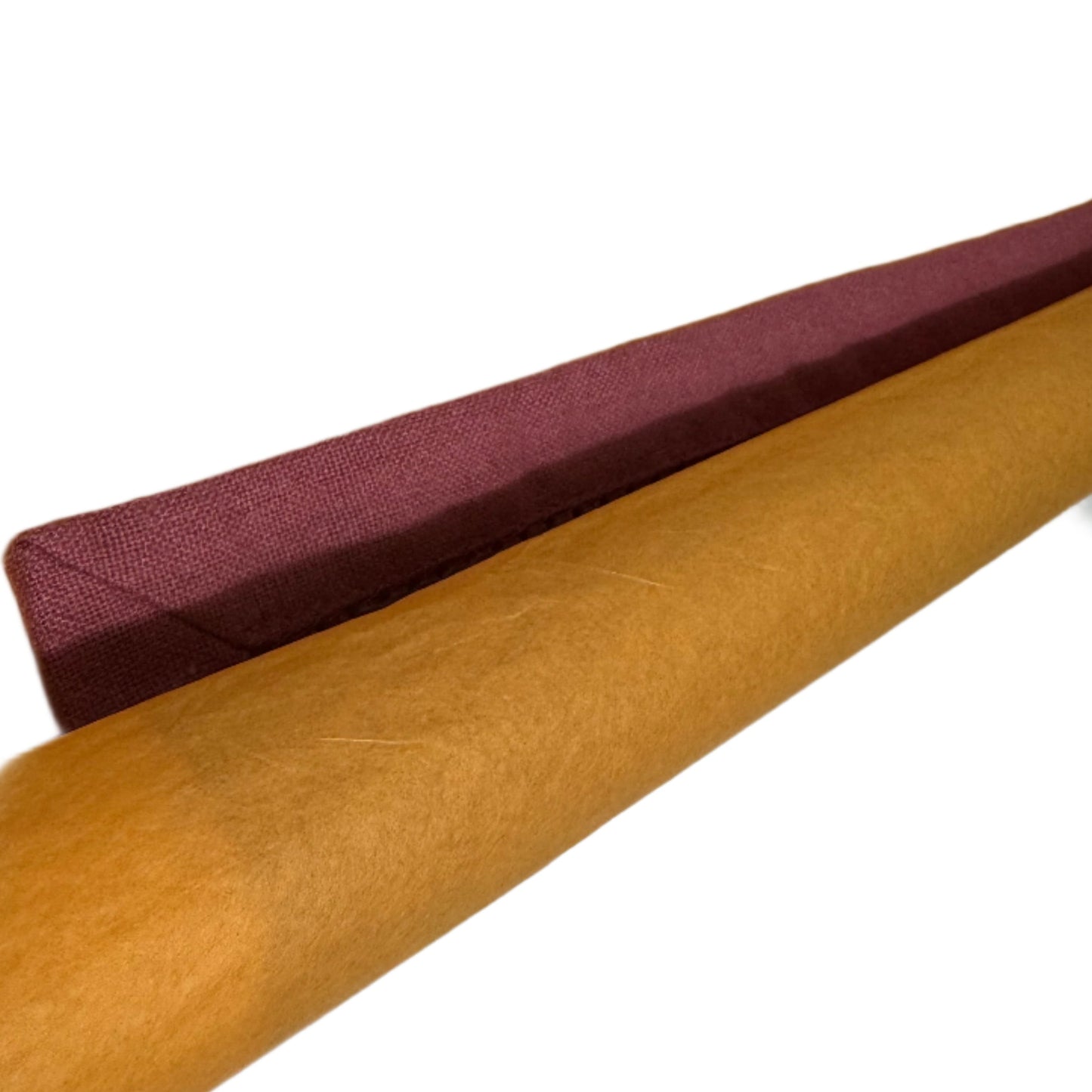 Two rolled cotton napkins, one in a rich burgundy and the other in a warm mustard yellow, both with visible stitching along the edges
