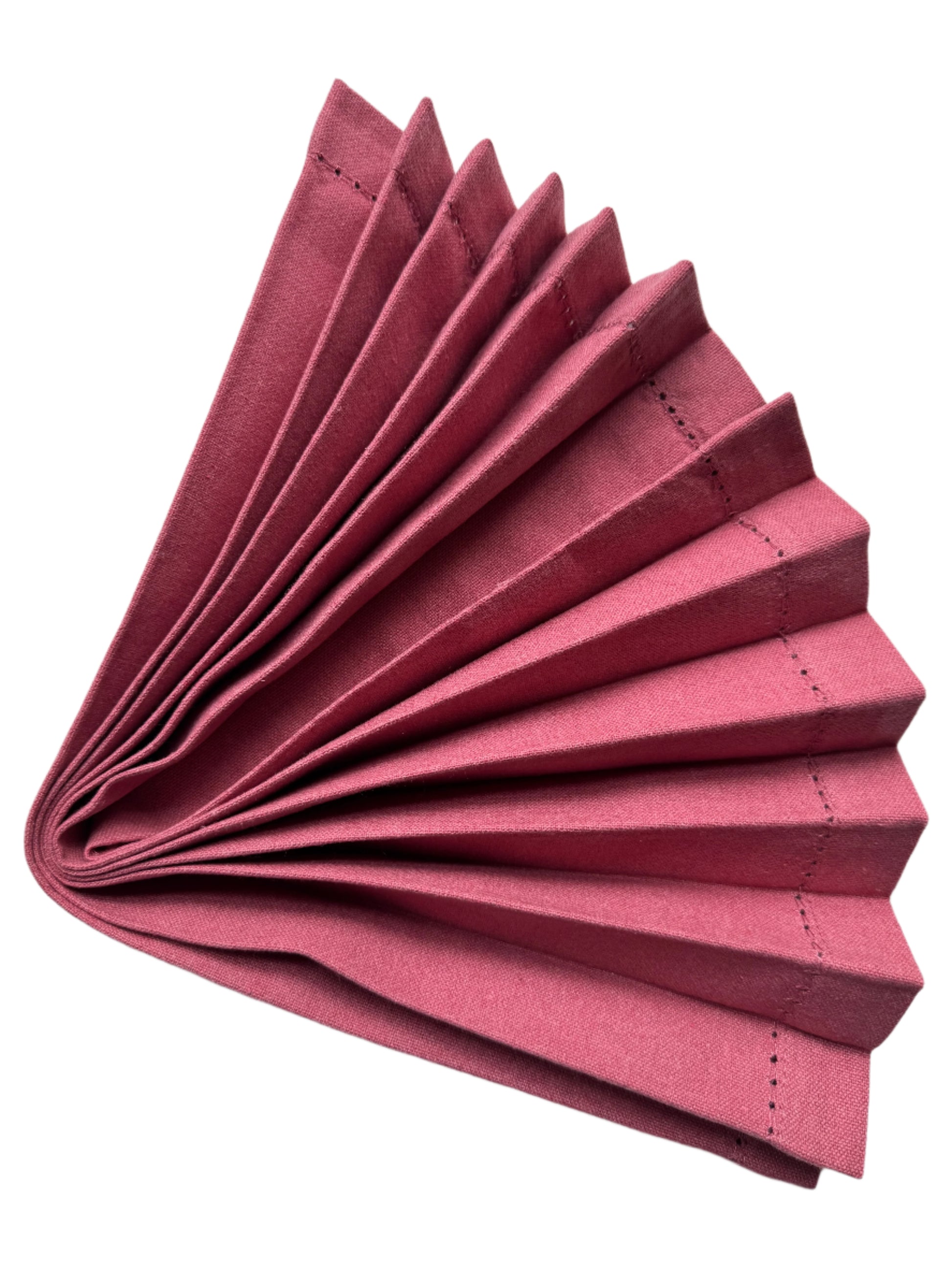 Burgundy cotton napkin elegantly folded in a fan shape, showcasing neat pleats with fine stitched edges, creating a sophisticated presentation