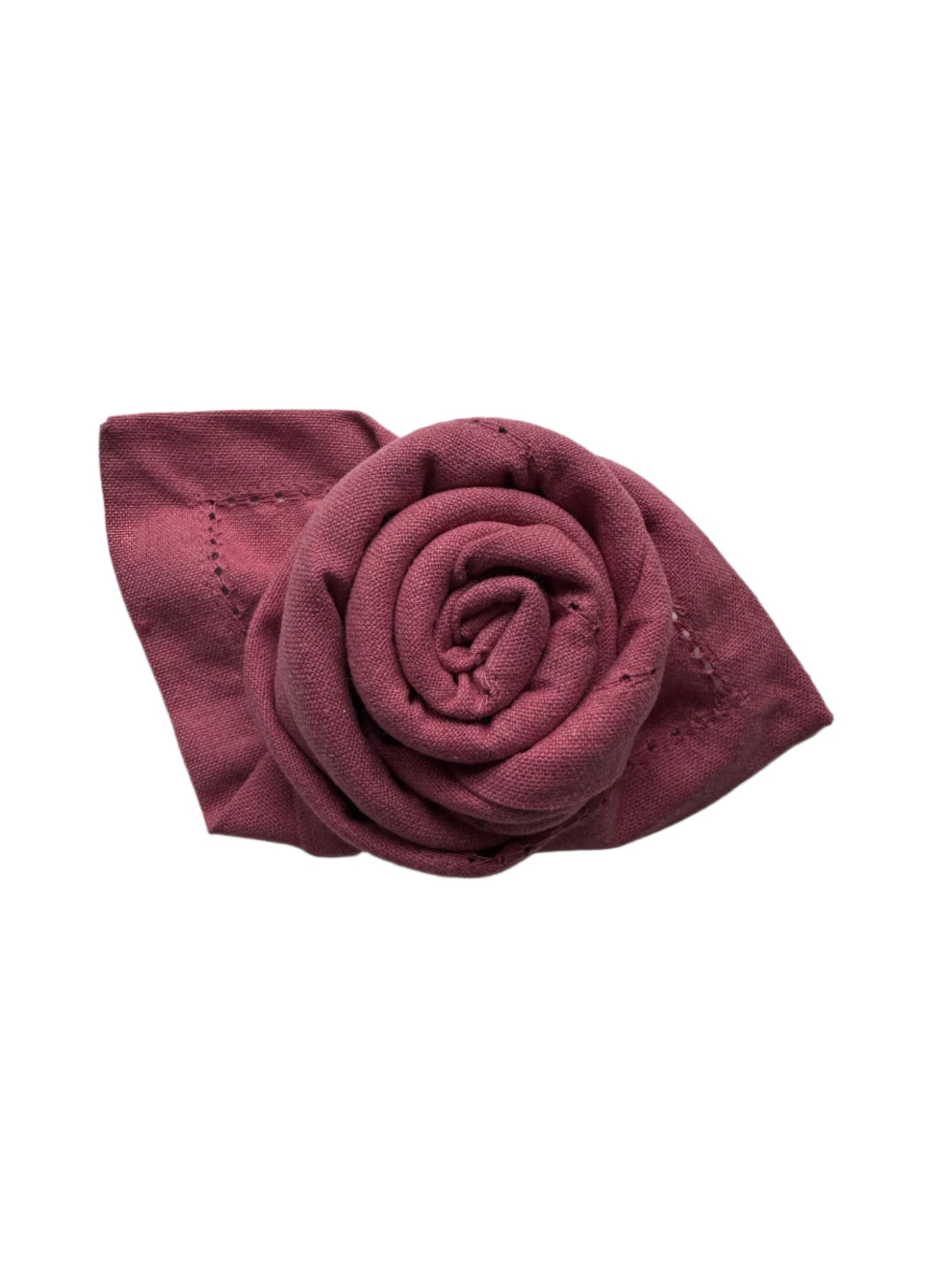 A folded cotton napkin in a soft burgundy shade, expertly rolled to resemble a rose with a neat, decorative leaf design on the side, showcasing fine stitching along the edges