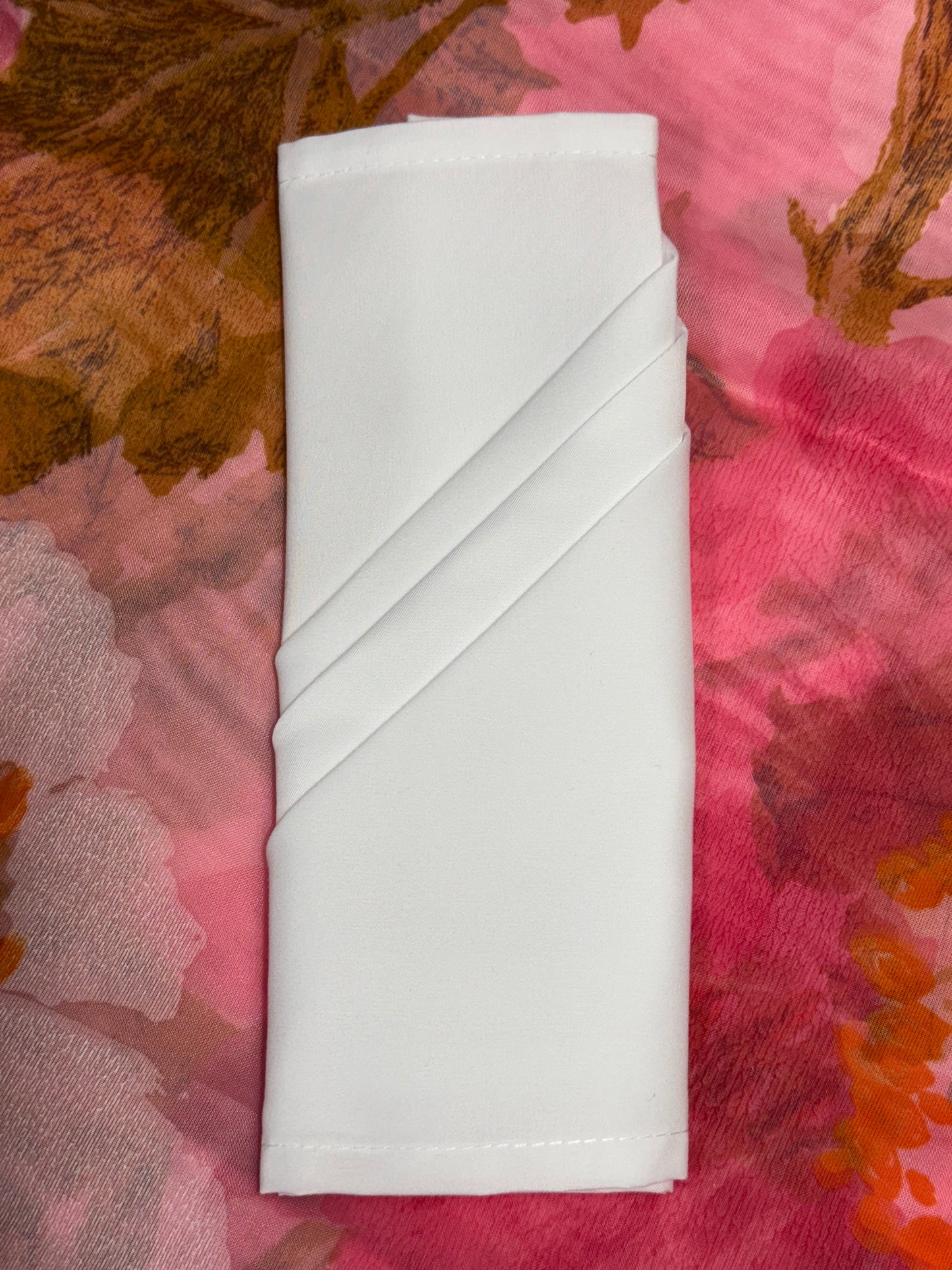 White polyester cloth napkins 18 x 18 inches set of eight by Monarch Linens shown folded and styled for formal and everyday table settings