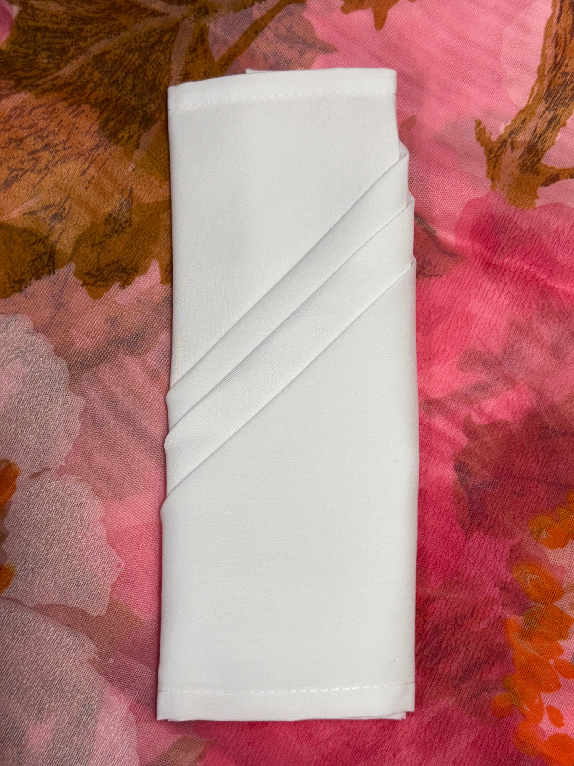 White polyester cloth napkins 18 x 18 inches set of eight by Monarch Linens shown folded and styled for formal and everyday table settings