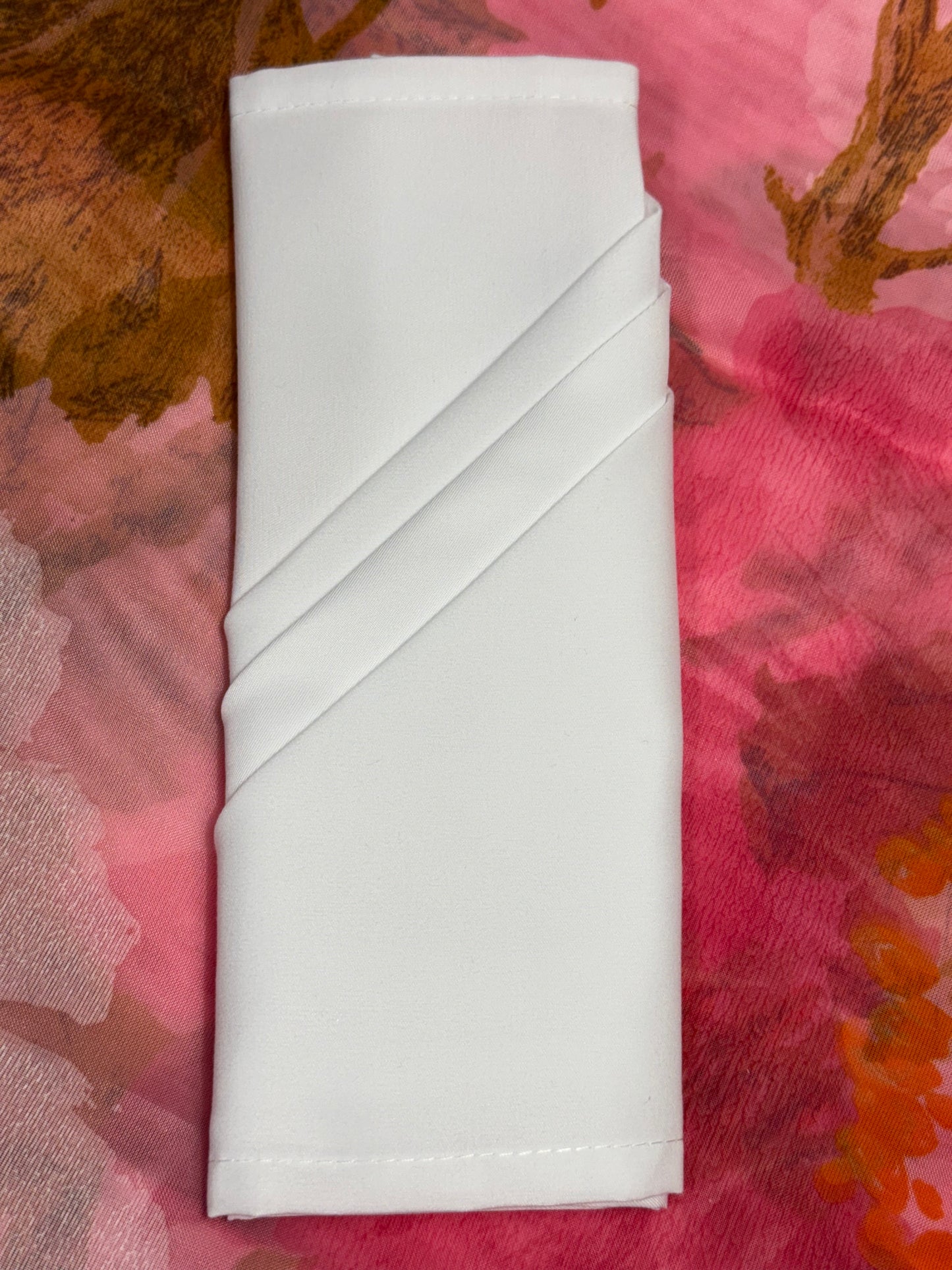 White polyester cloth napkins 18 x 18 inches set of eight by Monarch Linens shown folded and styled for formal and everyday table settings