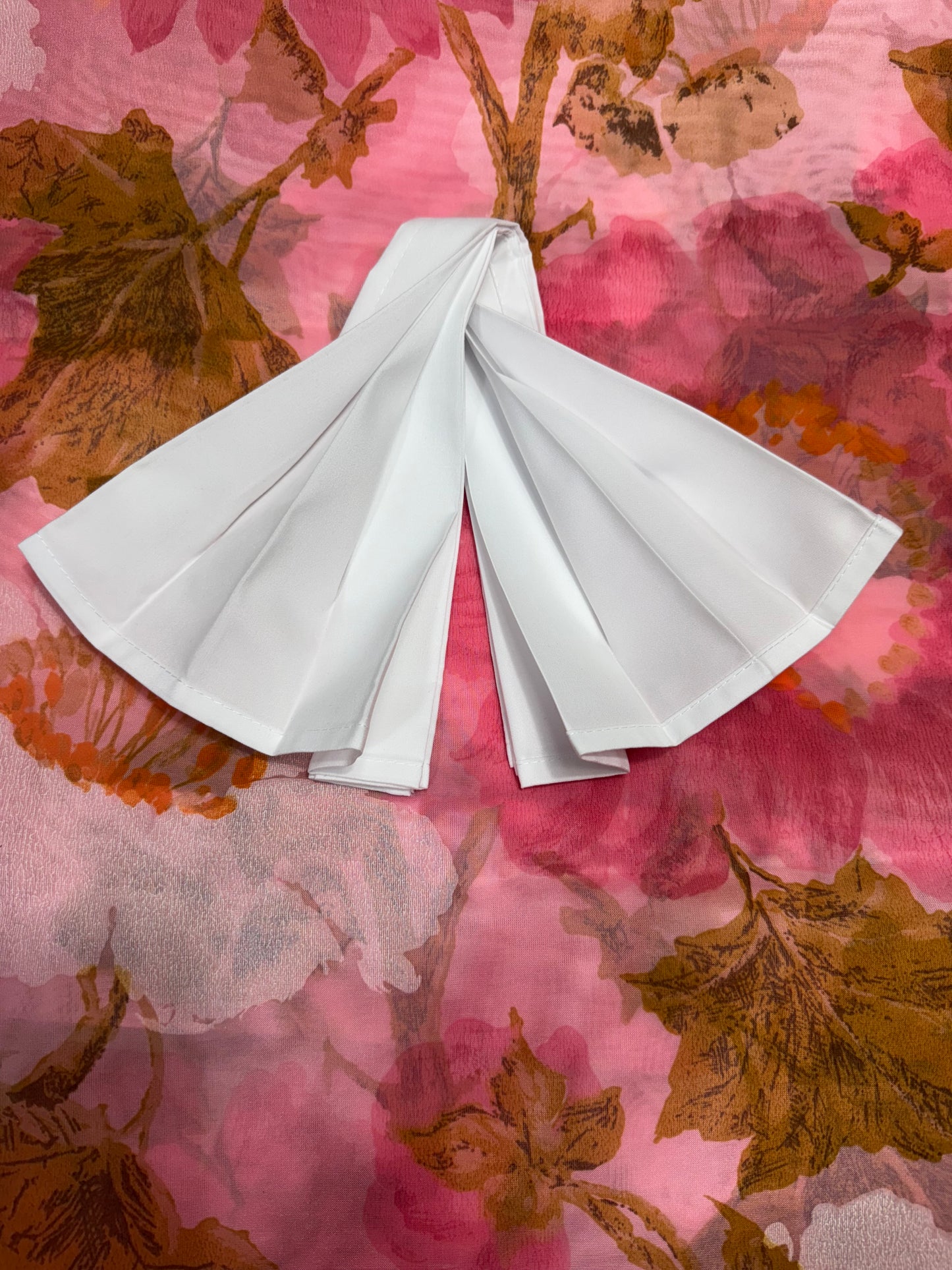 White polyester cloth napkins 18 x 18 inches set of eight by Monarch Linens shown folded and styled for formal and everyday table settings