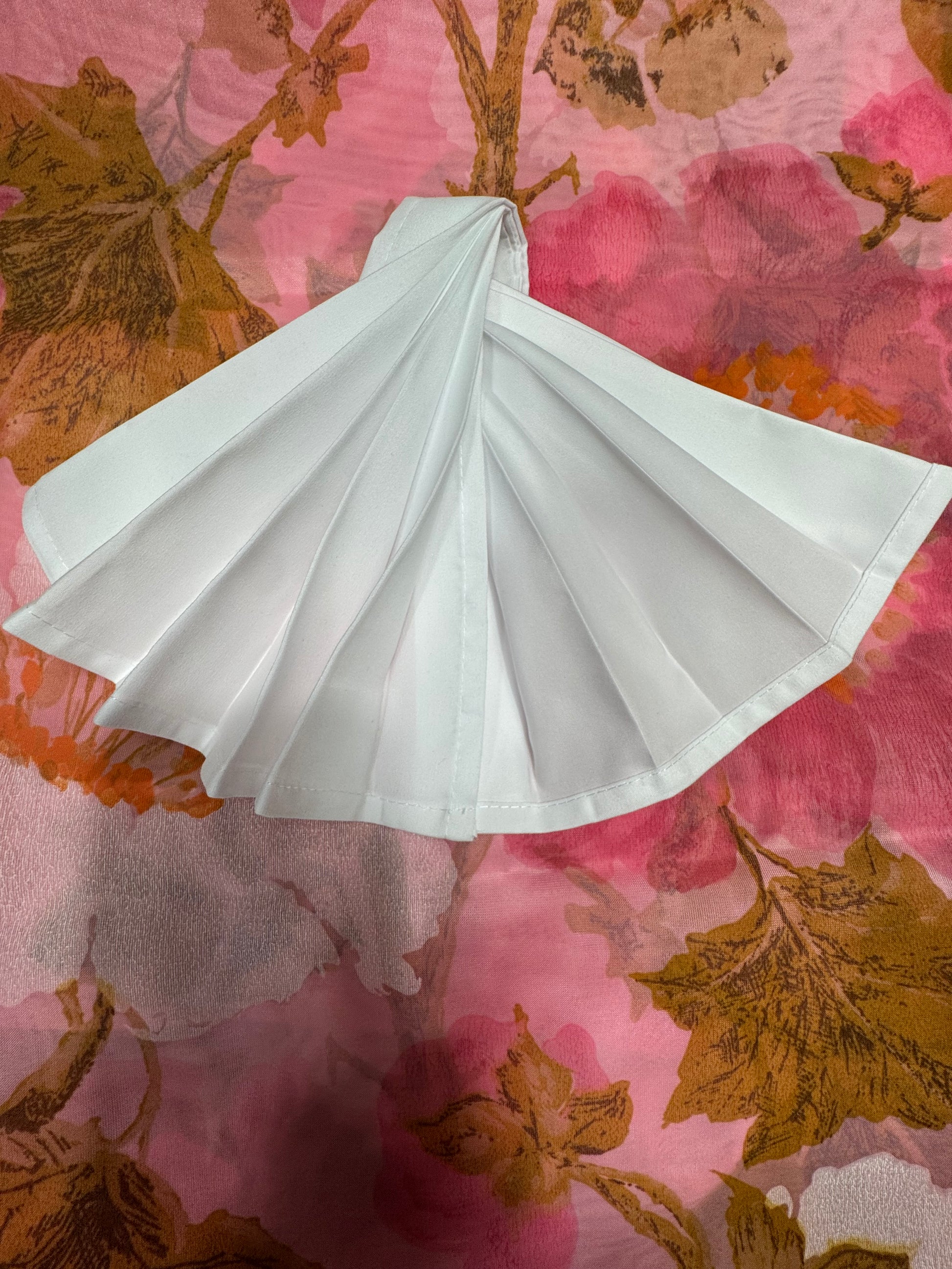 White polyester cloth napkins 18 x 18 inches set of eight by Monarch Linens shown folded and styled for formal and everyday table settings