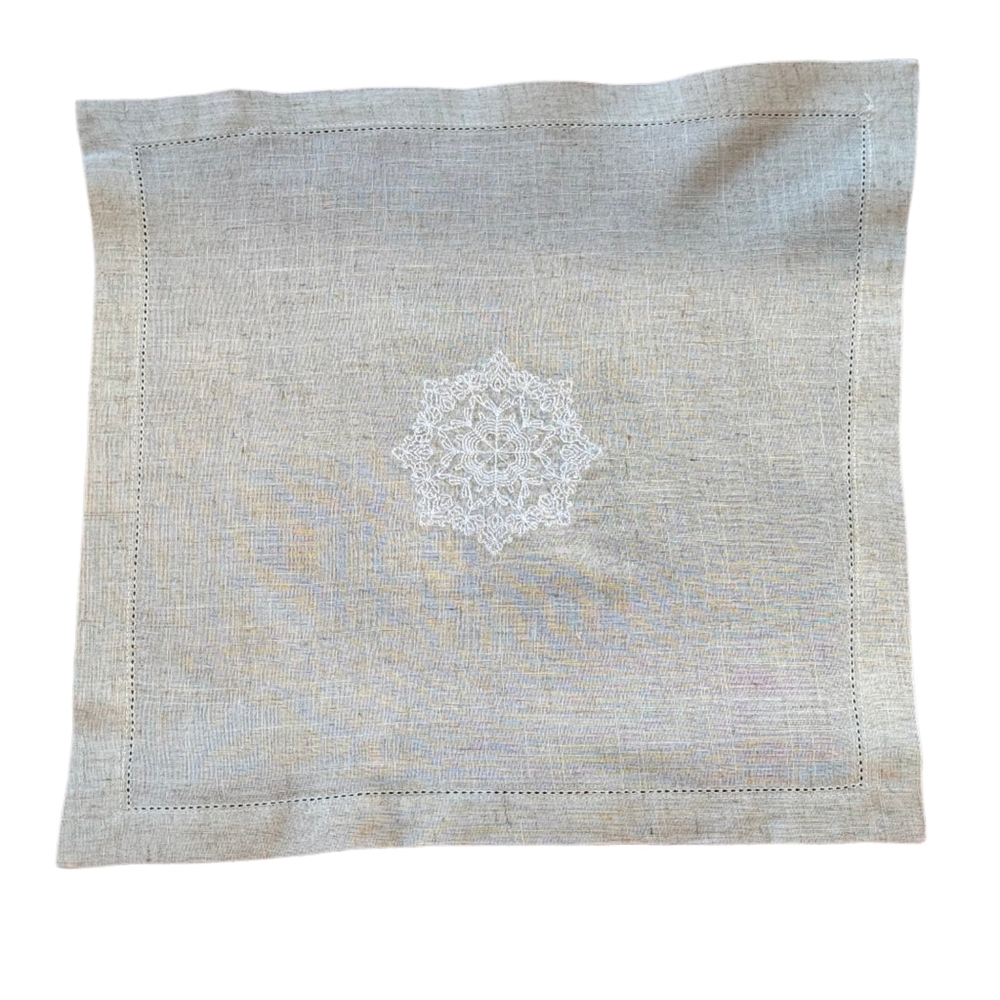 Natural beige linen dinner napkin with delicate embroidered detail and hemstitched edges, 17 x 17 inch reusable cloth napkin styled on an elegant table setting