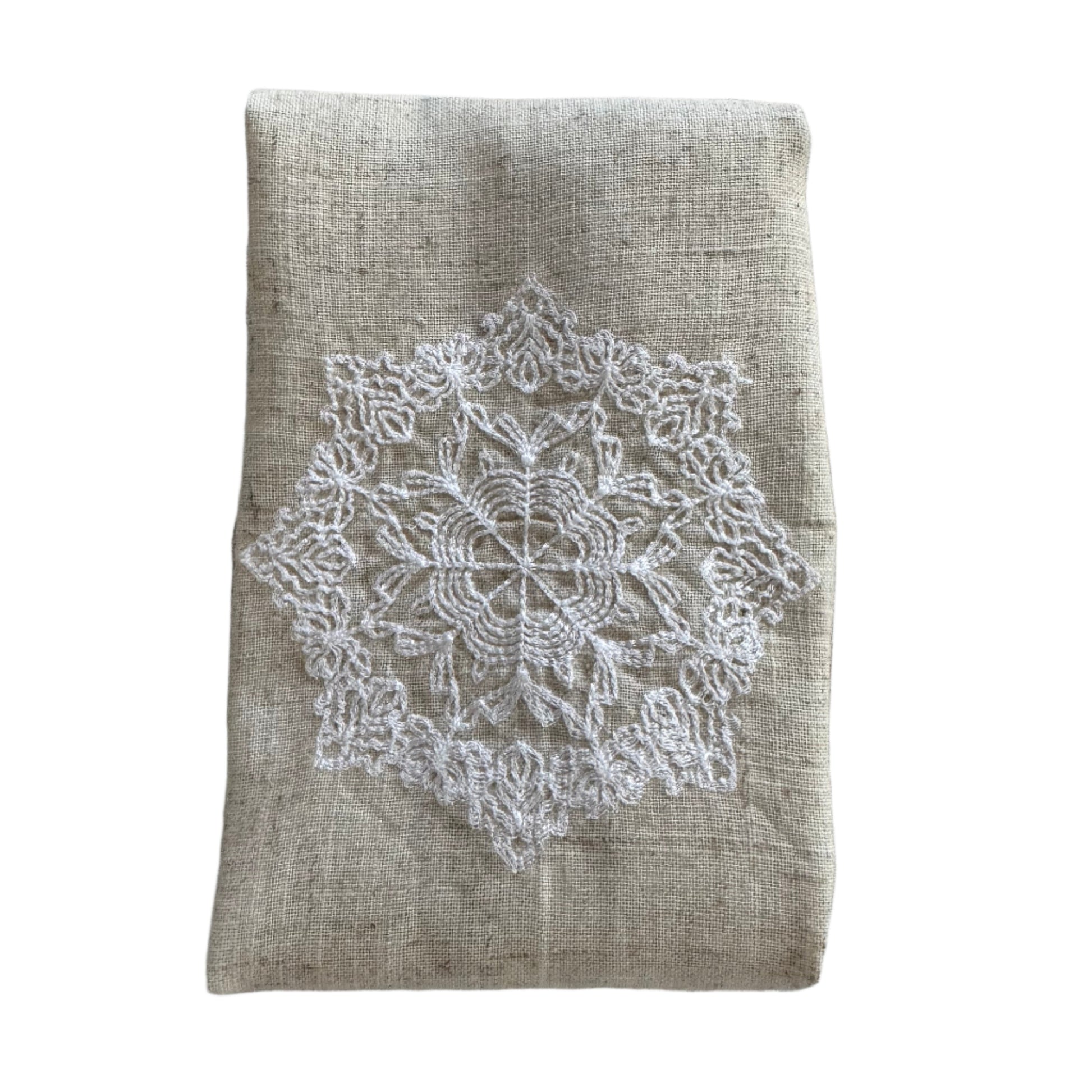 Natural beige linen dinner napkin with delicate embroidered detail and hemstitched edges, 17 x 17 inch reusable cloth napkin styled on an elegant table setting