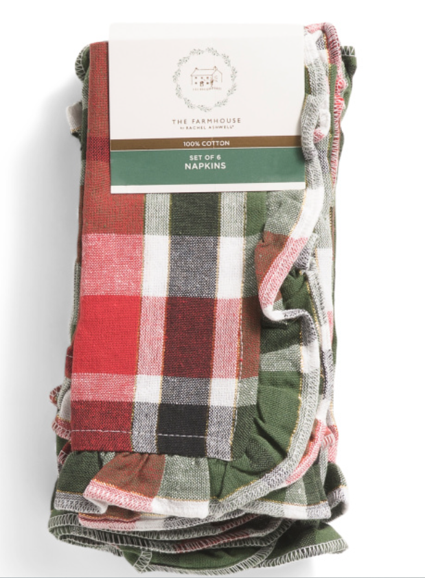 A set of 6 plaid napkins by The Farmhouse by Rachel Ashwell, featuring a red, green, and white checkered pattern with a ruffle border, made from 100% cotton. Each napkin measures 18" x 18"