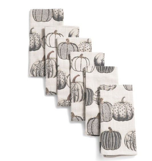 Set of six cotton fall napkins with metallic pumpkin pattern, folded for table display.