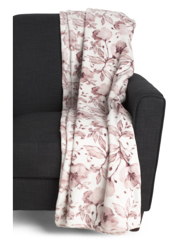 Velvet plush floral throw blanket draped over a chair with soft decorative finish