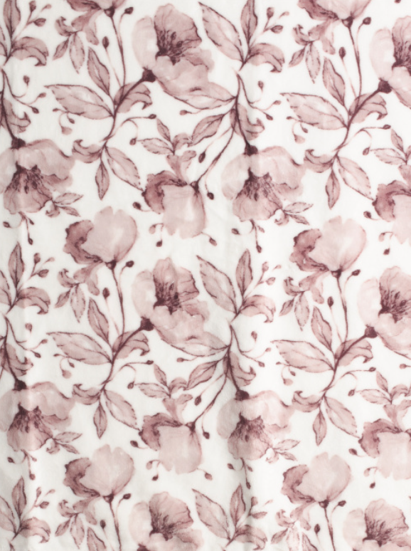 Velvet plush floral throw blanket draped over a chair with soft decorative finish