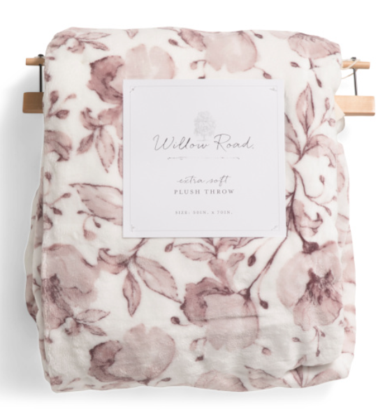 Velvet plush floral throw blanket draped over a chair with soft decorative finish