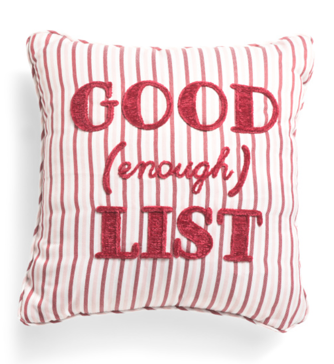 Decorative pillow with red text on a white background