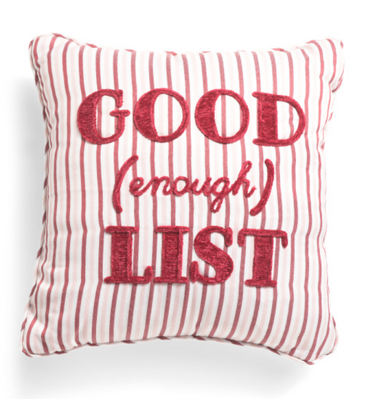 Decorative pillow with red text on a white background