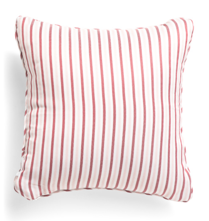 Striped pillow with red and white pattern on a white background