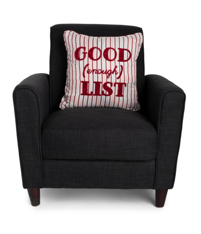 Black armchair with a red and white striped pillow that says 'GOOD (enough) LIST' on a white background.