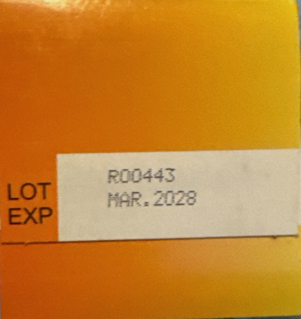 Orange box with a label showing 'LOT EXP' and 'MAR. 2028' on a textured surface.