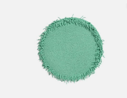 Round green rug with frayed edge on a white background