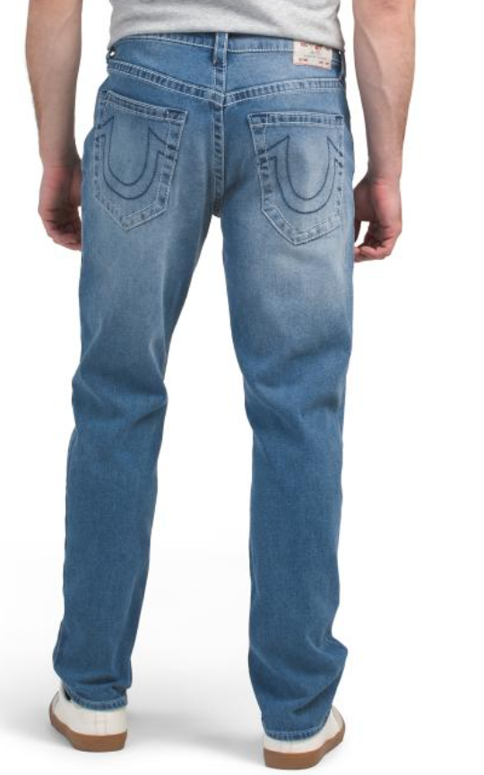 Blue jeans worn by a person on a white background
