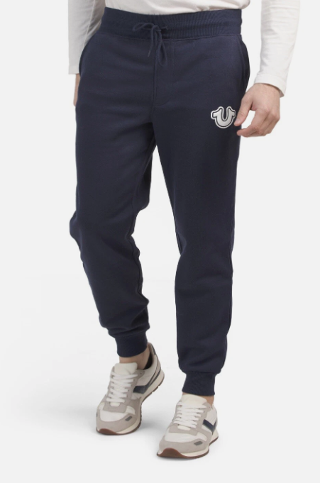 Navy blue jogger pants with a logo on a white background