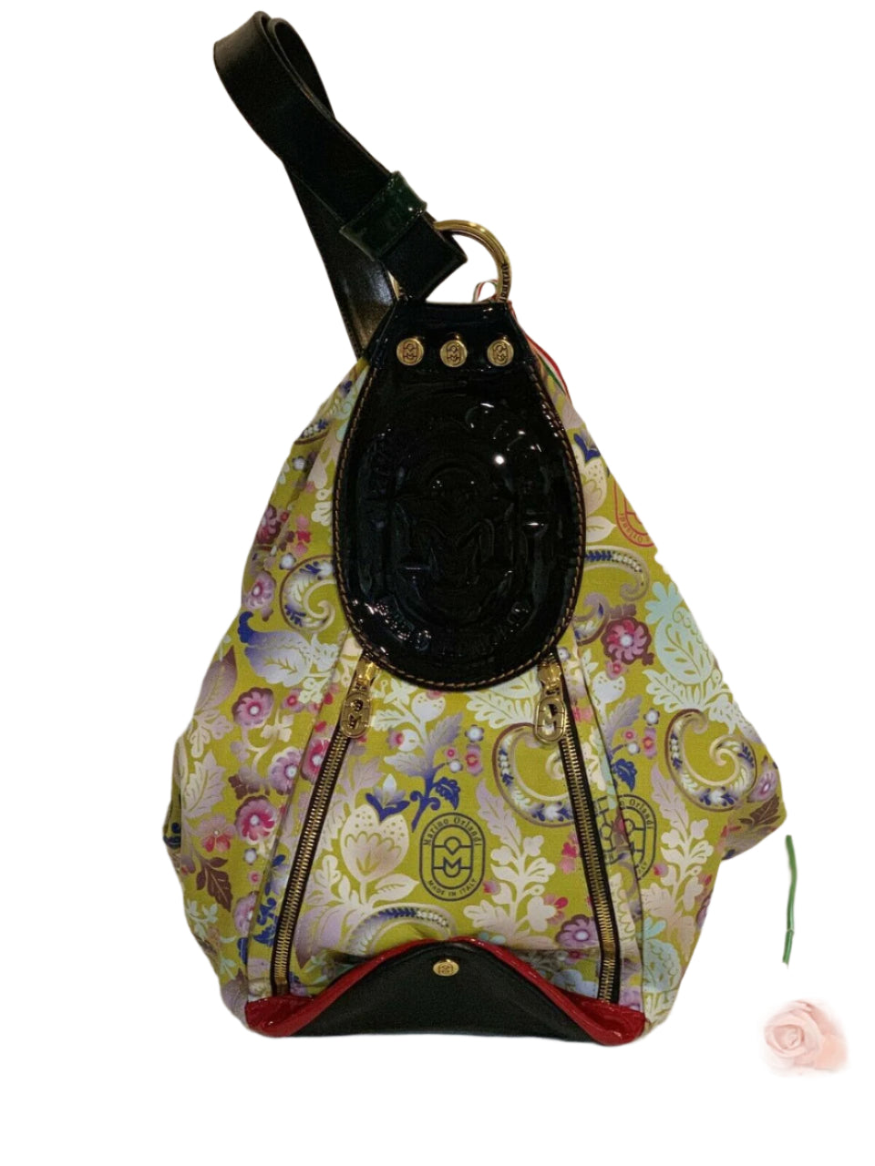 A floral patterned leather convertible backpack handbag with black patent leather trim and gold-tone hardware.
