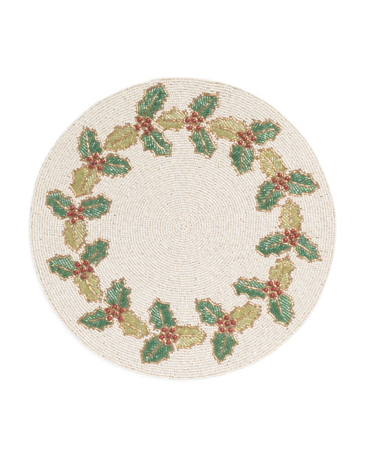 Round holiday placemat featuring a beaded holly leaf and berry design on a neutral background, ideal for Christmas table décor.