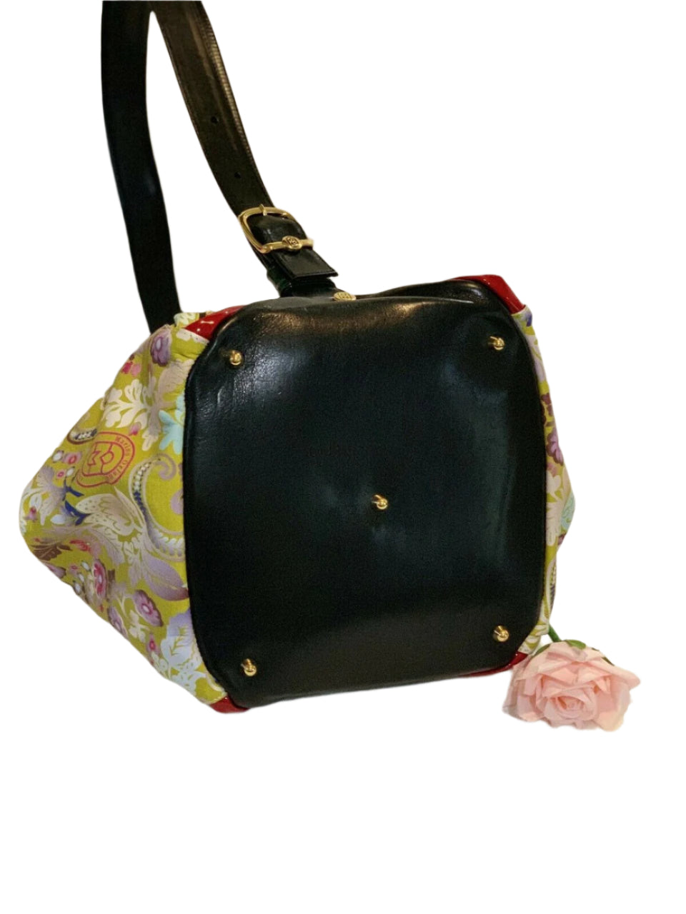 Black handbag with floral fabric sides on a white background