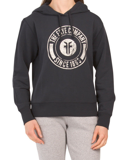 Black pullover hoodie with circular logo graphic on front and drawstring hood